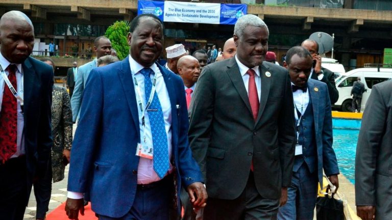 Kenya’s former prime minister Raila Odinga (L) walks with Africa Union Commission Chairperson Moussa Faki (R) in Nairobi, Kenya on November 8, 2018